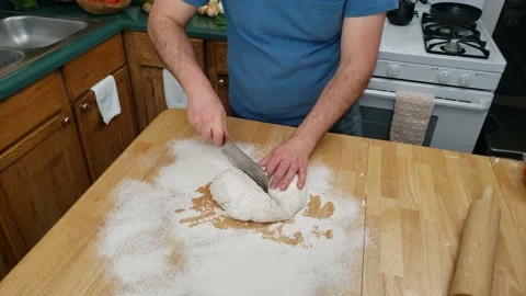 Time lapse of flour being spread on table and dough being split in half Video stock 159449069
