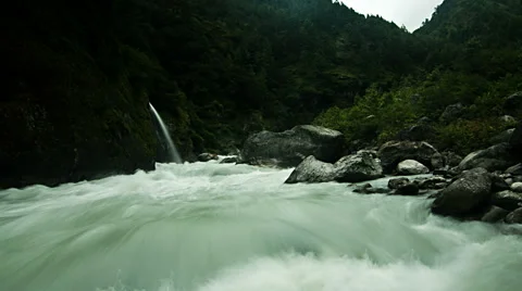 Time lapse of flowing river and waterfall in forest Stock Footage 62389015