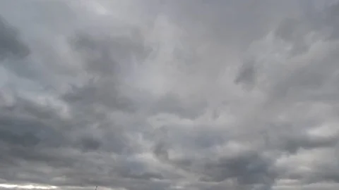 Time lapse: fluffy blue and gray clouds are floating by the sky. Video stock 129269793