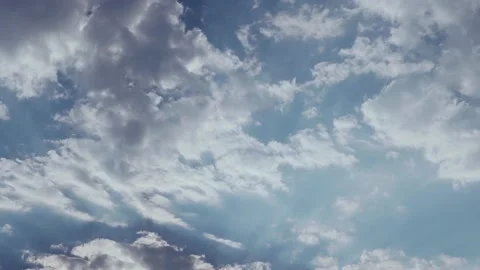 Time Lapse of Fluffy Clouds on a Clear Blue Sky. The Sun Shines Through The Clou Stock Footage 135656037