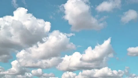 Time lapse fluffy clouds floating in a clear blue sky during the day. The Stock-Footage 338290606