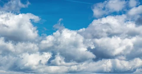 Time Lapse of Fluffy Clouds Moving Across Blue Sky Background Stock Footage 310333815