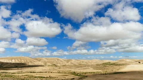 Time-lapse of fluffy clouds over hills in desert Stock Footage 90224487