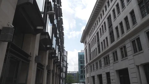 Time lapse. Fluffy clouds over a narrow street with buildings. Stock Footage 107951523