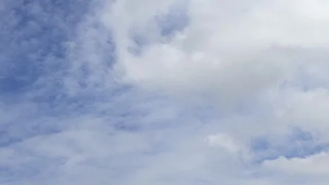 Time lapse of fluffy cumulus and stratus clouds moving fast across blue sky Stock Footage 341234023