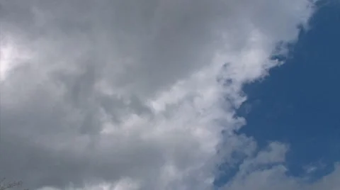 Time lapse fluffy cumulus clouds against light blue sky Stock Footage 8522413