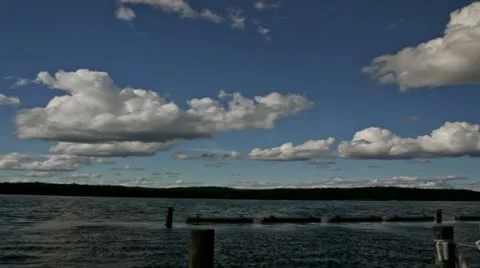 Time lapse fluffy cumulus clouds against light blue sky Stock Footage 12030702