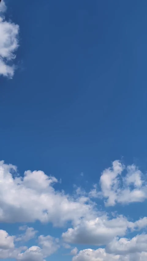 Time-Lapse of Fluffy Cumulus Clouds on a Sunny Day. Vertical video Stock Footage 284327350
