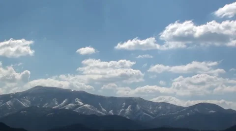 Time lapse: fluffy sky clouds above snowy mountains peaks Stock Footage 67576989