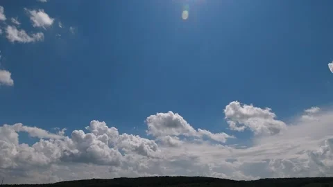 Time lapse: fluffy white clouds are floating by the sky. Stock Footage 135728067