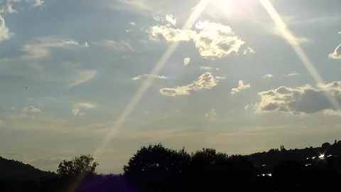 Time lapse with flying clouds in the colored sky and the sun Stock-Footage 100361612