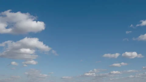 TIME-LAPSE: Flying white clouds on a blue sky Stock Footage 136139959