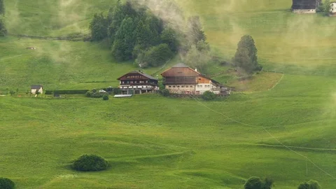 Time lapse fog in front of alpine mountain farm Stock Footage 77024257