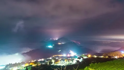 Time Lapse - Fog moving over the urban lights at tea farm in Taiwan Stock Footage 248917062