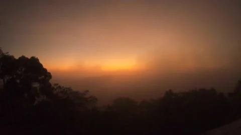 Time-lapse of foggy sunrise over Tikal ruins Stock Footage
