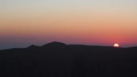 A time lapse footage captures the sun setting over the majestic Hajar Mountains Stock Footage 318648080