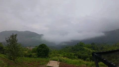 Time-lapse footage of clouds flowing through the valley in the early morning Stock Footage 313342692
