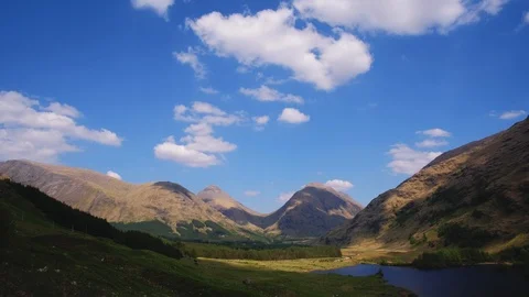 Time lapse footage of clouds moving on blue sky, Scottish Highlands, UK Stock Footage 90511535