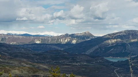 Time-lapse footage of clouds over the French mountain landscape, moving toward Stock Footage 341037900