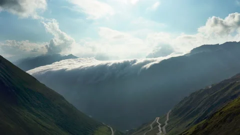 Time lapse footage, clouds slide down the mountains like a waterfall in the Stock Footage 161547957