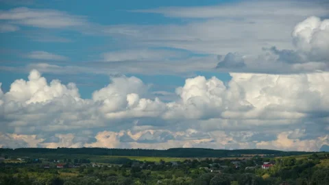 Time lapse footage of fast moving white puffy cumulus clouds on blue clear sky Stock Footage 162945935