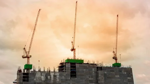 Time-lapse footage of High crane works on building site with view of a skyscr Stock Footage