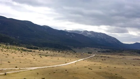 Time lapse footage of large field and mountain peak Stock Footage 173474322