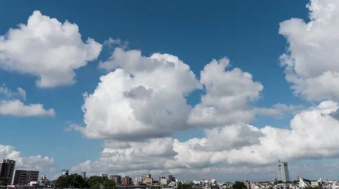 Time-lapse footage of white clouds in the Tokyo summer sky and cityscape, Tokyo, Stock Footage