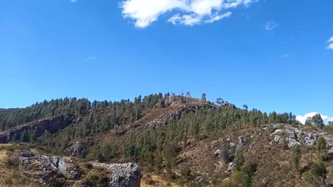 Time lapse of forest with rocks and distant clouds Stock Footage 293093483