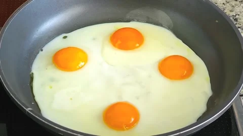Time-lapse of four eggs frying in a pan, cooking breakfast fast motion close Stock Footage 340359735