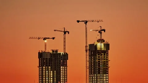Time lapse of four high-rise construction cranes on the construction of two Stock Footage 222538720