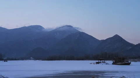 Time Lapse of Frozen Lake Distant Mountain Thin Cloud Stock Footage 337942159