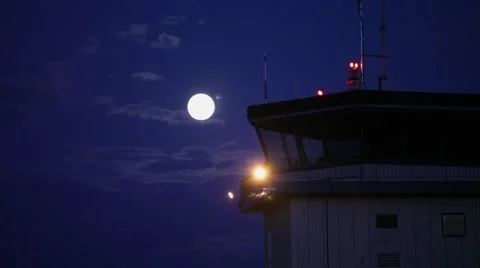 Time lapse of full moon in clouds. Airport control tower. Stock Footage 45489542