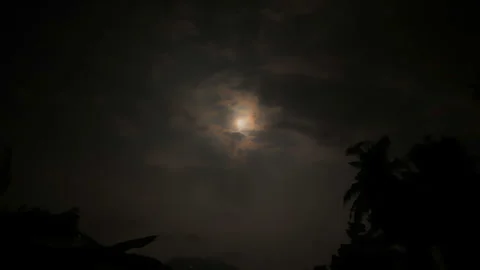 Time lapse of full moon illuminating moving clouds at night, Bali, Indonesia 스톡 동영상 336485414