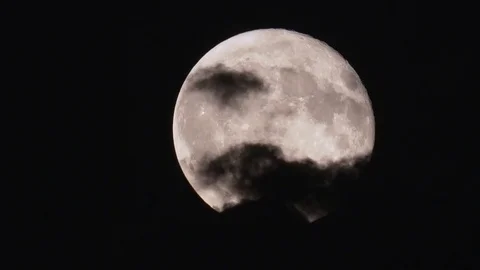 Time-lapse of full moon moving through clouds at night Stock Footage
