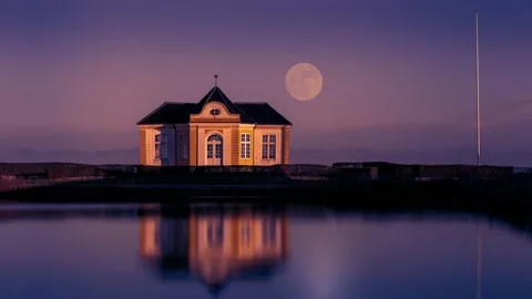 Time lapse of full moon rising over lonely uninhabited house Stock Footage 145835784