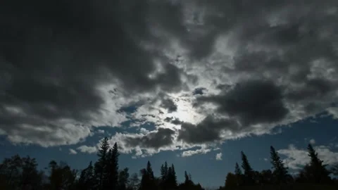 Time lapse of a full moon slowly emerging from behind stormy looking clouds Stock Footage 140220004