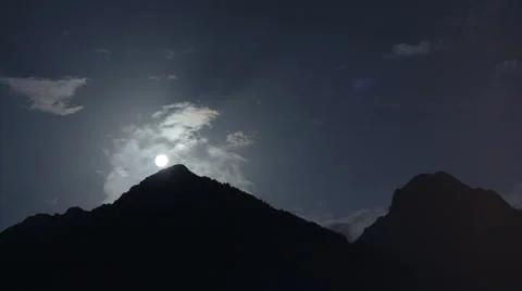 Time-lapse of full moon under mountains with dramatic sky Stock Footage 67208209