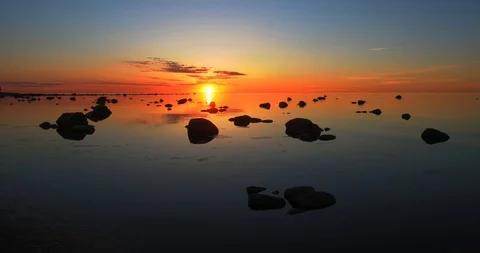 Time lapse of a full red sunset above a still sea Stock Footage 101741004