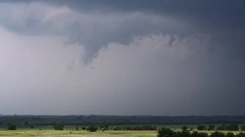 Time-lapse funnel cloud starting to take shape at base of thunderstorm over Stock Footage 59513710