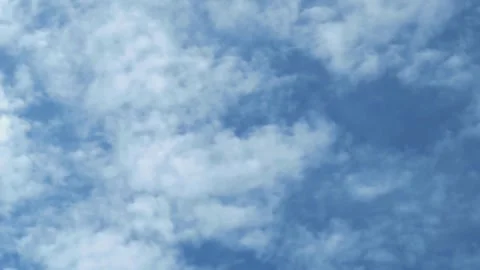 Time lapse of gentle clouds moving quickly across a blue sky during the day Stock Footage 323239710