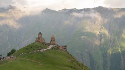 Time lapse of Gergeti Trinity Church with clouds flowing over the mountain. Stock Footage 246606510