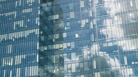 Time lapse of a glass skyscraper with clouds reflected in the office windows Stock Footage 229021283