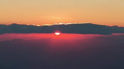 Time-lapse Glowing Red Sun Rising Through Thick Clouds at Horizon Stock Footage 330156478