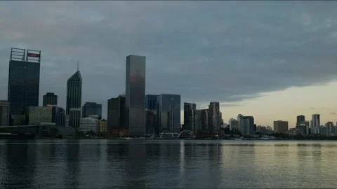 Time lapse golden light through heavy clouds over Perth cityscape 4K Stock Footage 311650049
