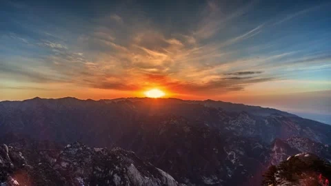 Time Lapse of Golden Sunset Distant Mountain Peak Group Flowing Cloud Glow Stock Footage 337938151