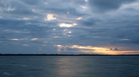 Time lapse of gorgeous clouds at dawn over water Stock Footage 67614913