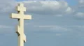 Time-lapse of gray clouds flying over stone cross on grave at the cemetery 4k or 4k+ Resolution