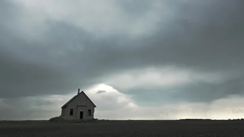 Time lapse of gray rain clouds drifting past and old brick schoolhouse  Stock Footage 252385407