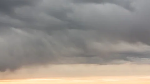 Time lapse. Gray rainy overcast sky changes to fire red by rays of setting sun Stock Footage 139591536